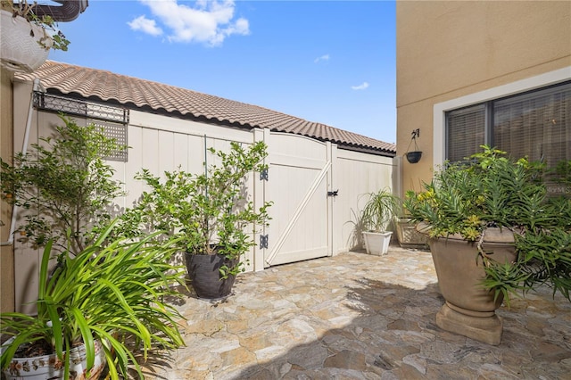 view of patio featuring fence and a gate