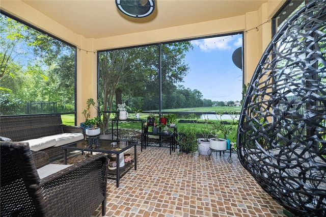 sunroom featuring a wealth of natural light and outdoor lounge area
