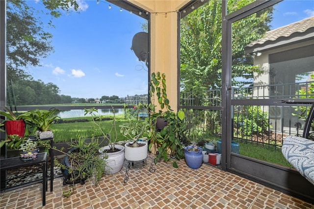unfurnished sunroom with a water view