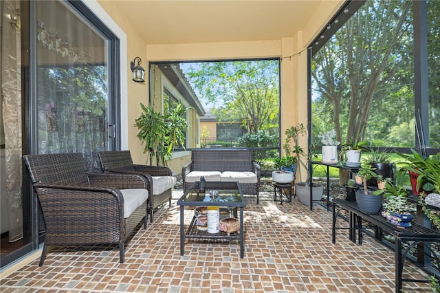 sunroom / solarium featuring outdoor lounge area