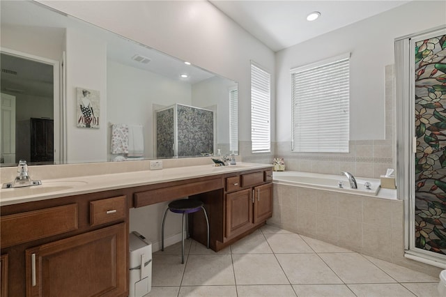 bathroom featuring a sink, tile patterned floors, a bath, and double vanity