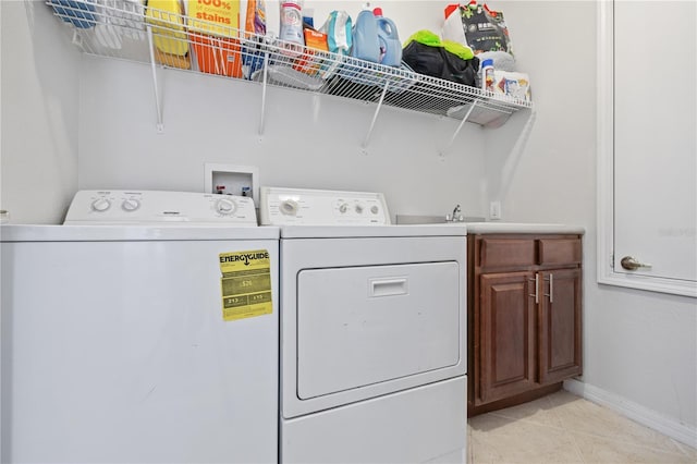 washroom featuring cabinet space, separate washer and dryer, baseboards, and light tile patterned floors