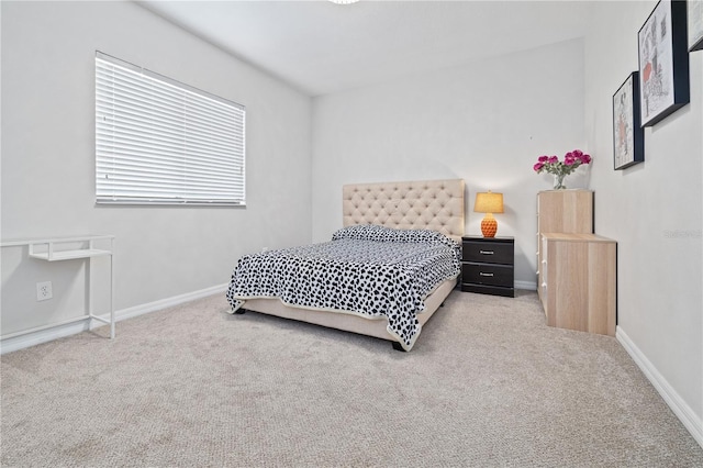 carpeted bedroom featuring baseboards
