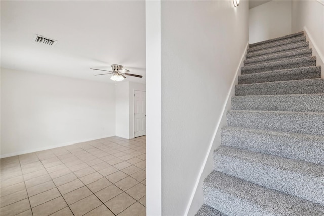 staircase with tile patterned flooring and ceiling fan