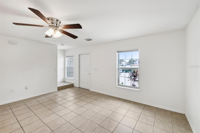 empty room featuring light tile patterned floors and ceiling fan