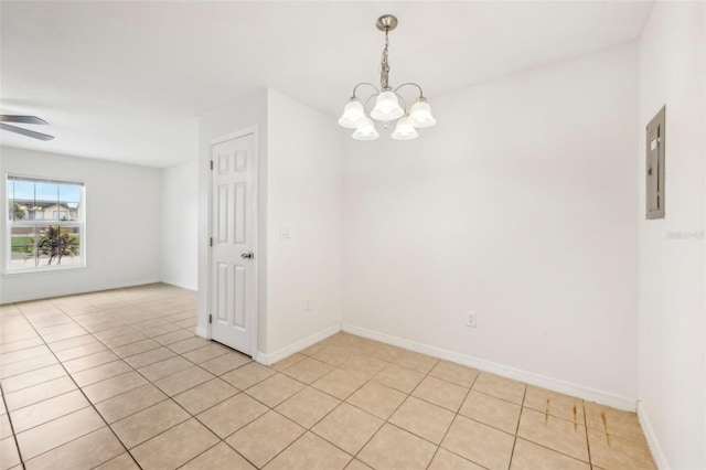 unfurnished room with ceiling fan with notable chandelier, light tile patterned floors, and electric panel