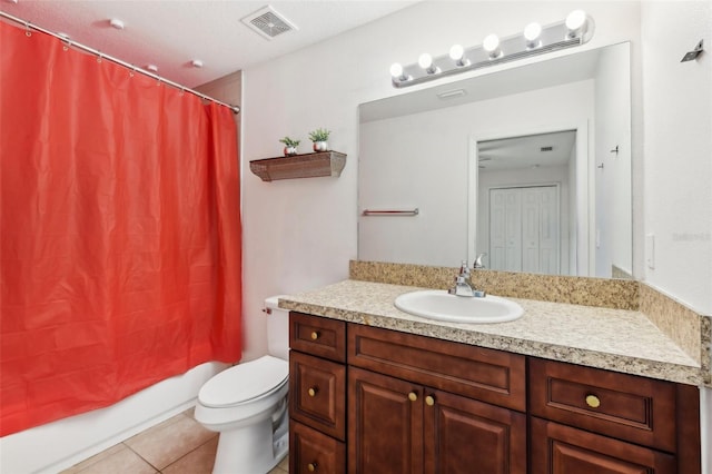 full bathroom with vanity, toilet, shower / bath combo with shower curtain, and tile patterned flooring