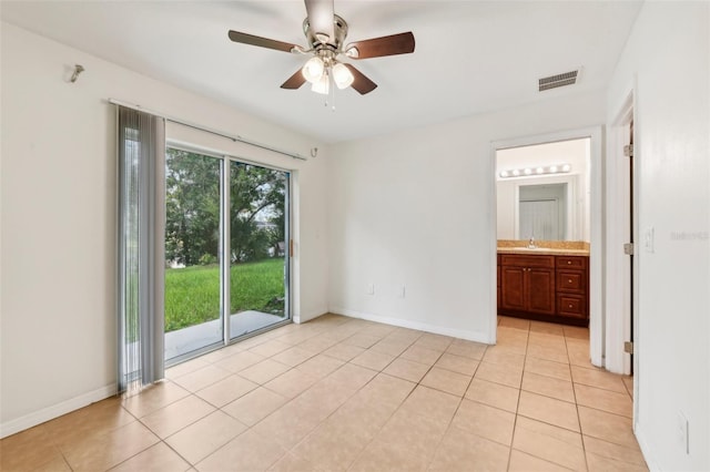 unfurnished bedroom featuring ceiling fan, light tile patterned floors, access to outside, and ensuite bath