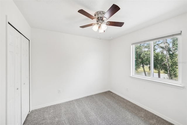 unfurnished bedroom featuring a closet, ceiling fan, and carpet