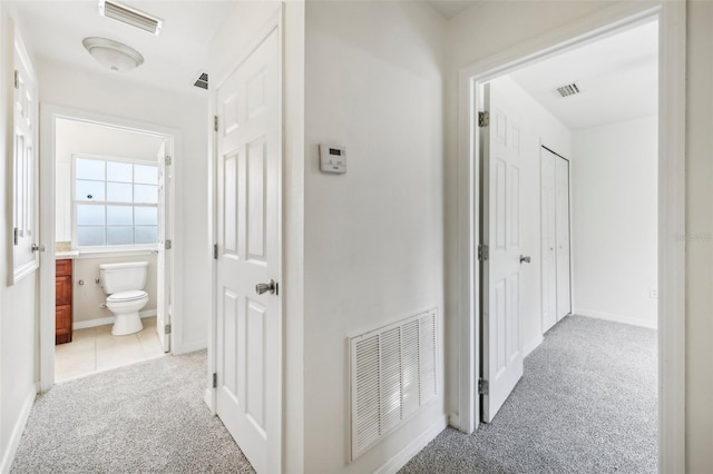 hallway with light colored carpet