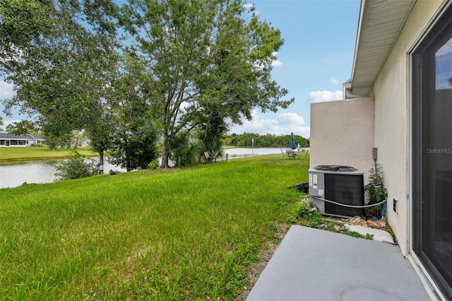 view of yard with a water view and cooling unit