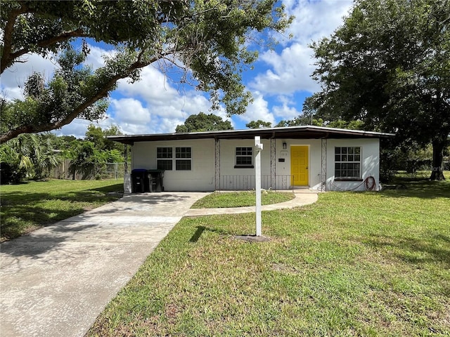 single story home featuring a front yard and a carport