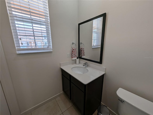 bathroom with vanity, toilet, and tile patterned flooring