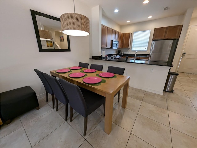 dining room with light tile patterned floors and sink