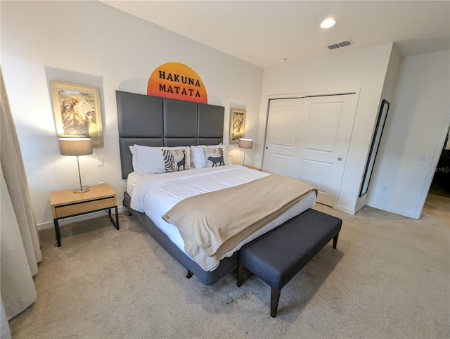 bedroom with a closet and light carpet