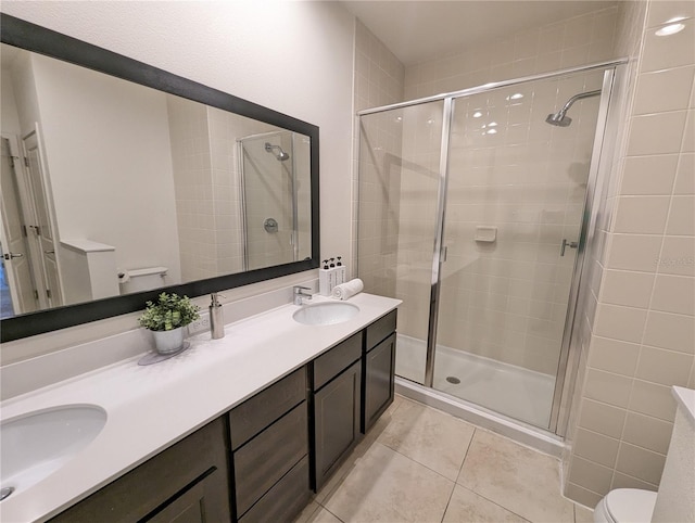 bathroom featuring tile patterned flooring, walk in shower, toilet, and vanity