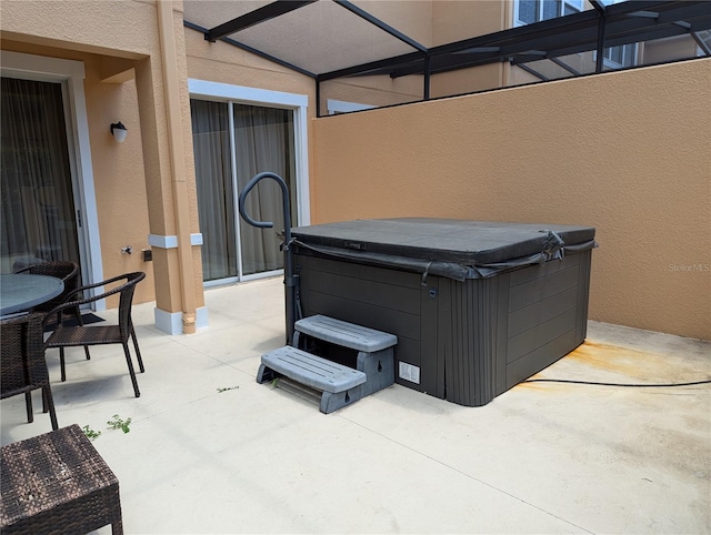 view of patio / terrace with a hot tub