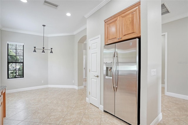 kitchen with stainless steel fridge, light tile patterned flooring, and crown molding