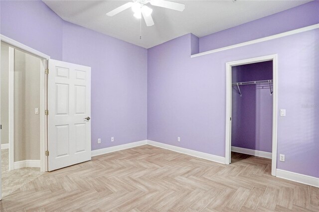 unfurnished bedroom featuring a closet, ceiling fan, and light parquet flooring