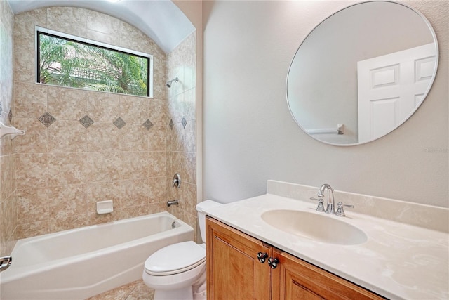 full bathroom featuring tile patterned floors, tiled shower / bath combo, vanity, and toilet