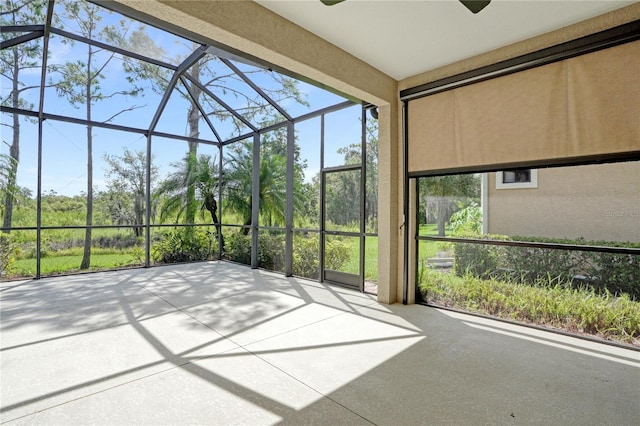 unfurnished sunroom featuring ceiling fan