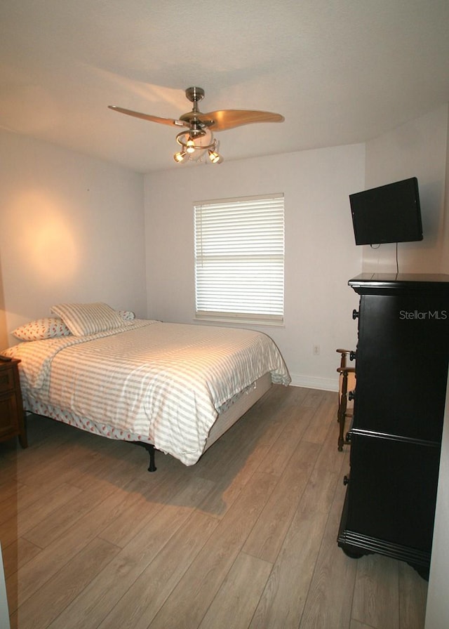 bedroom with ceiling fan and light wood-type flooring