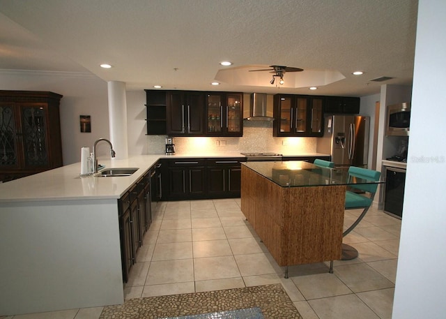 kitchen with open shelves, visible vents, appliances with stainless steel finishes, a sink, and wall chimney exhaust hood