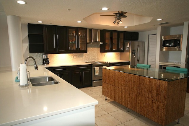 kitchen featuring light tile patterned floors, wall chimney exhaust hood, appliances with stainless steel finishes, open shelves, and a sink