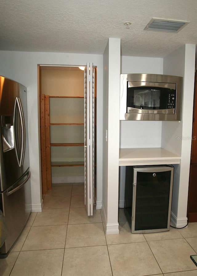 storage area with beverage cooler and visible vents