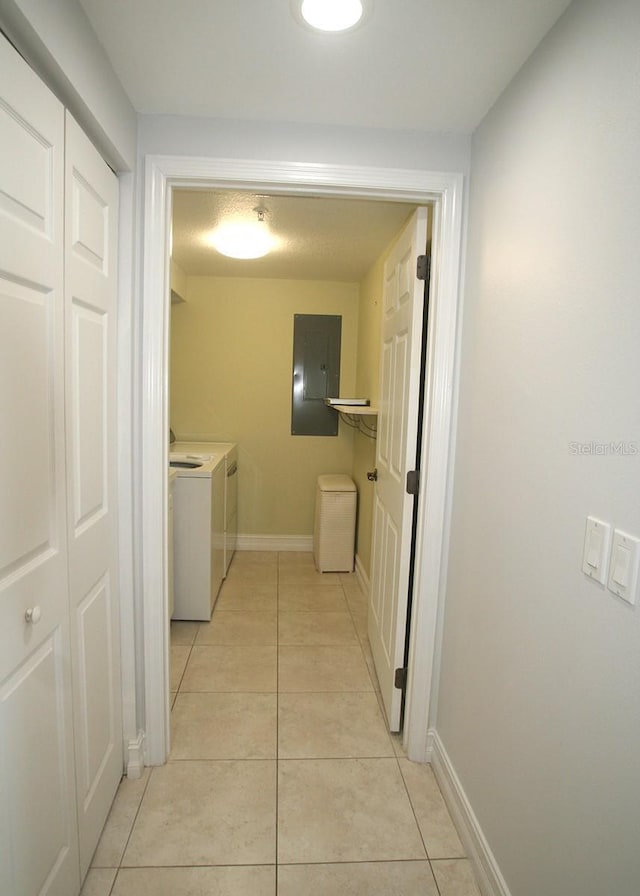 washroom with light tile patterned floors, laundry area, separate washer and dryer, and electric panel