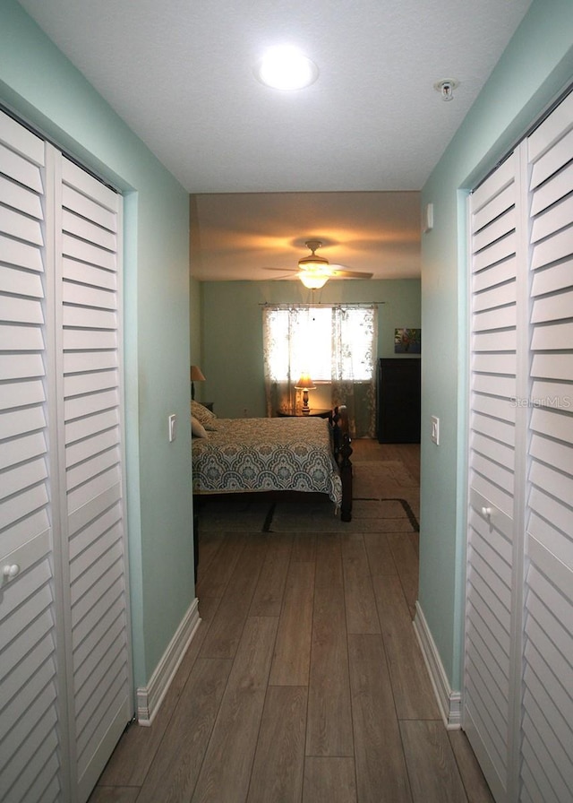 bedroom with baseboards and wood finished floors