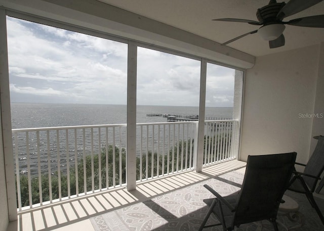 balcony with a ceiling fan and a water view