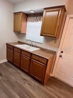 kitchen featuring dark hardwood / wood-style flooring and sink