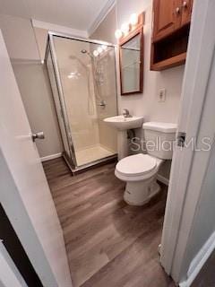 bathroom featuring walk in shower, toilet, and hardwood / wood-style floors