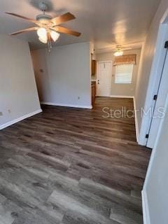 unfurnished room with ceiling fan and dark hardwood / wood-style flooring