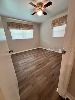 empty room featuring ceiling fan and dark hardwood / wood-style floors