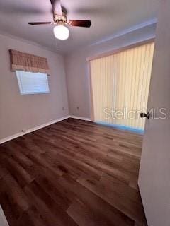 empty room featuring ceiling fan and dark wood-type flooring