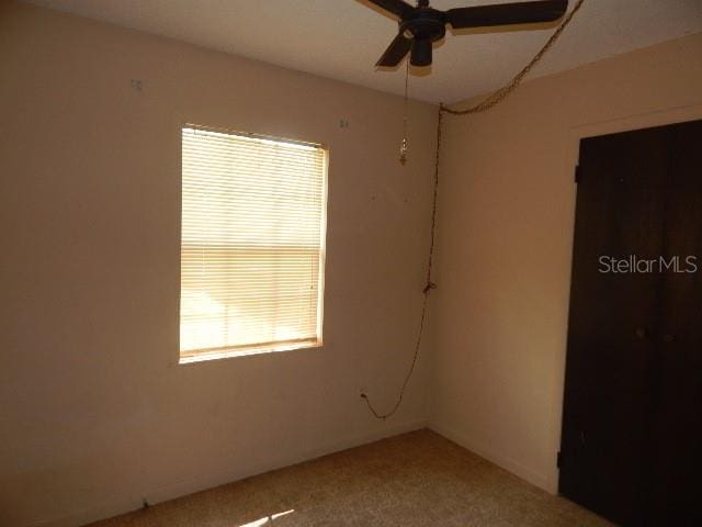 interior space with ceiling fan