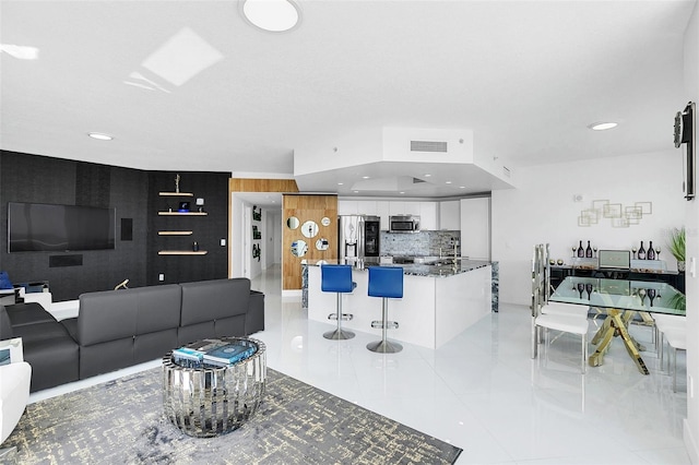 living room with sink and light tile patterned floors