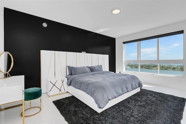 bedroom featuring a water view