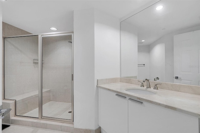 bathroom with vanity and a shower with door