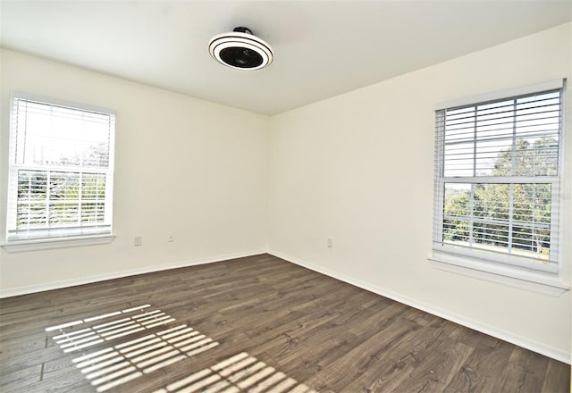 spare room with dark hardwood / wood-style flooring