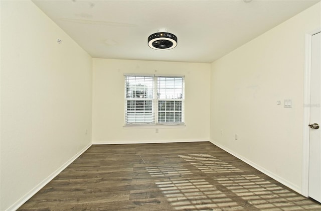 spare room featuring dark hardwood / wood-style flooring