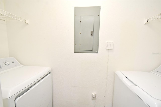 laundry area with electric panel and separate washer and dryer