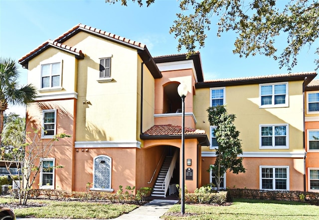 mediterranean / spanish house with a front lawn