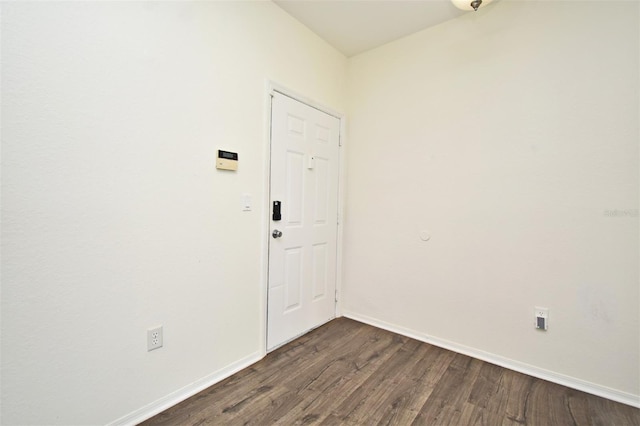 unfurnished room featuring dark hardwood / wood-style flooring