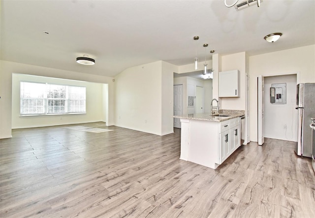 kitchen featuring sink, stainless steel appliances, hanging light fixtures, light stone counters, and white cabinets