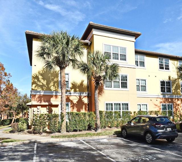 view of building exterior featuring uncovered parking