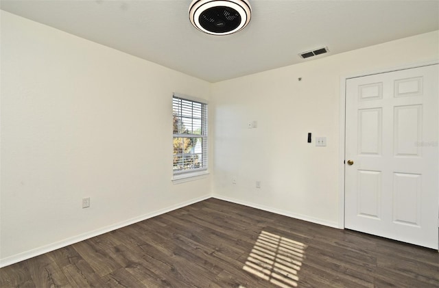 spare room featuring dark hardwood / wood-style flooring