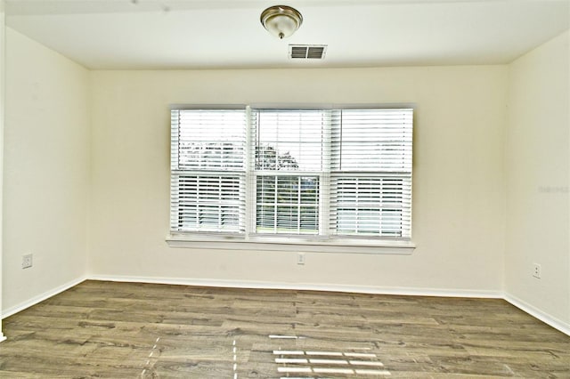 empty room with hardwood / wood-style floors